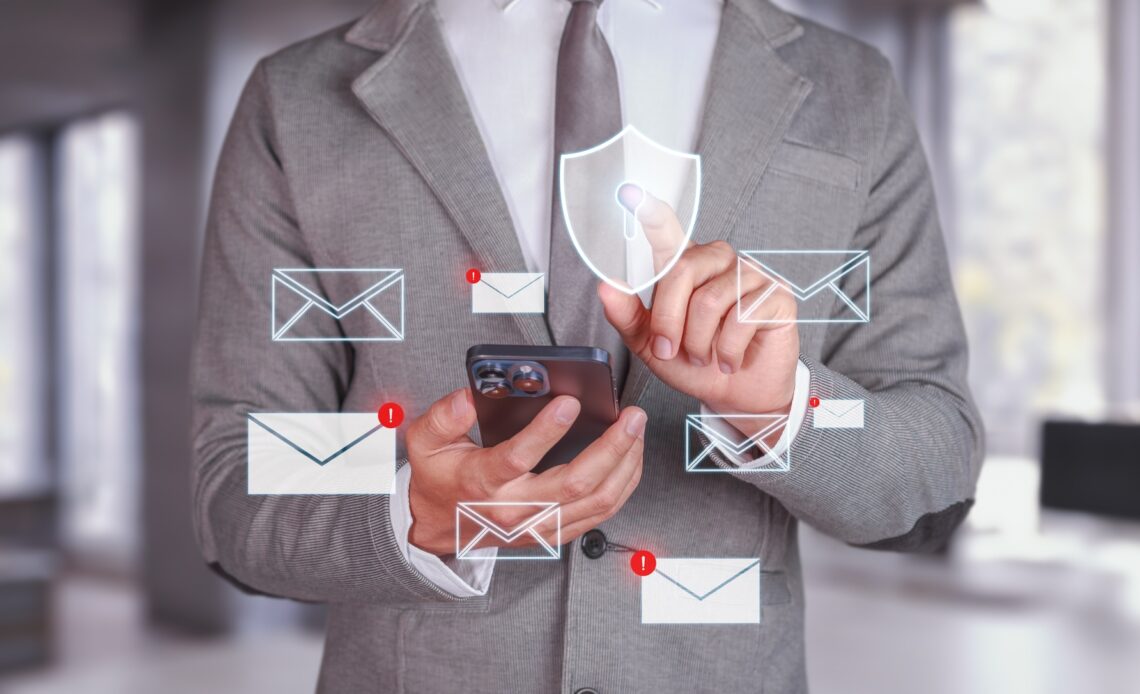 Cybersecurity and Email Protection. Businessman using smartphone with email notifications.