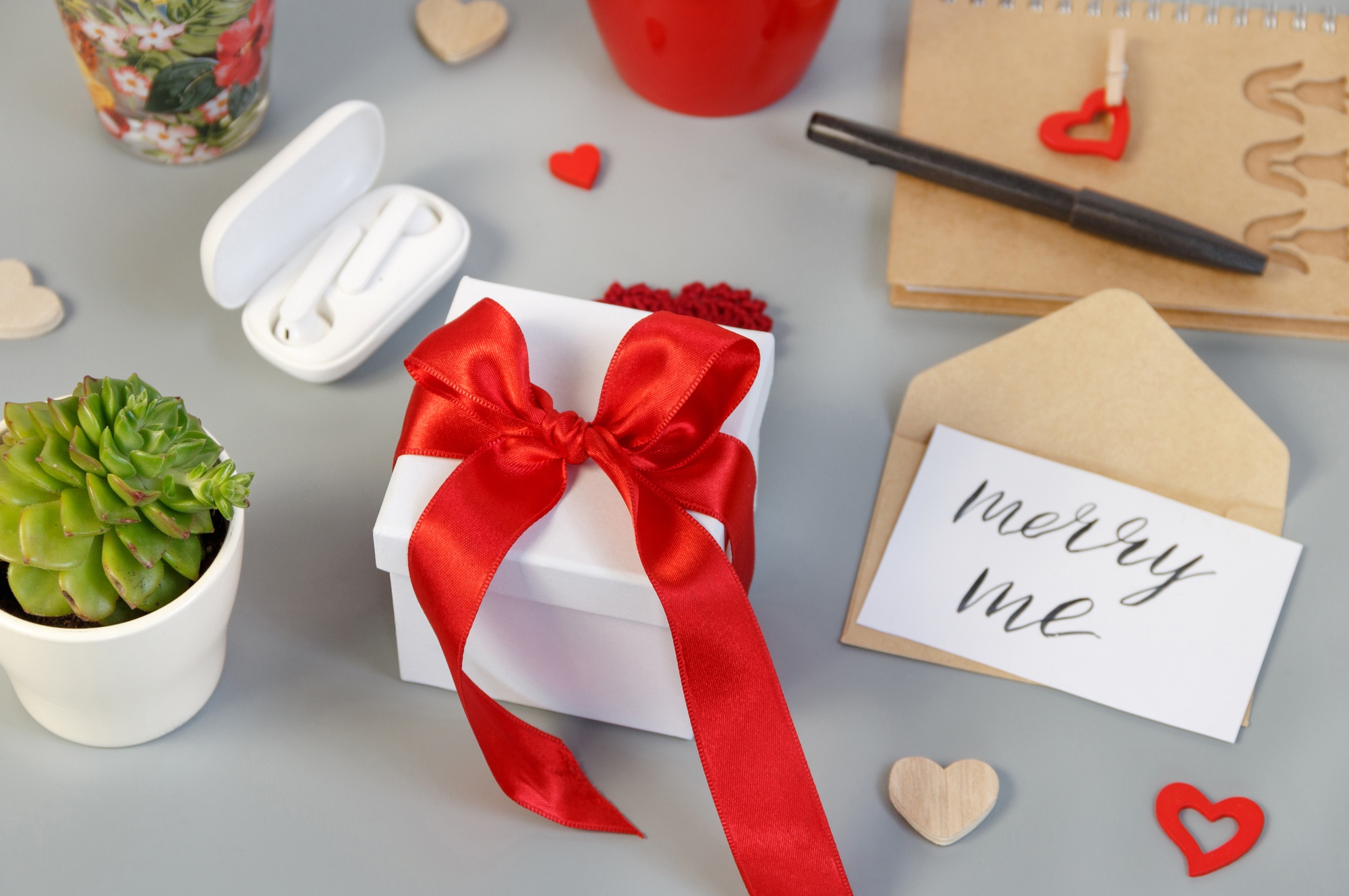 Present with MARRY ME card on grey table
