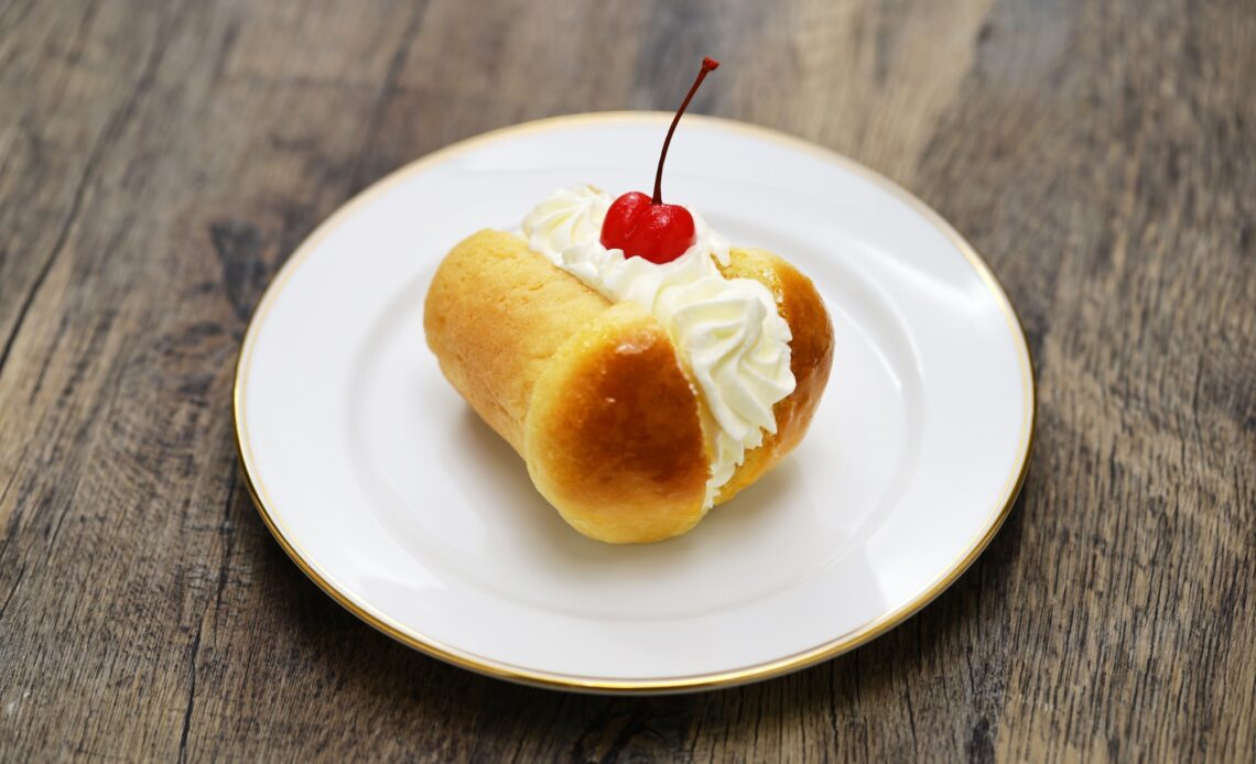 rum baba ( baba au rhum ) decorated with whipped cream