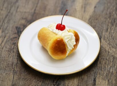 rum baba ( baba au rhum ) decorated with whipped cream