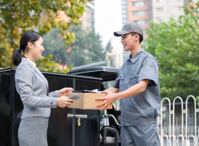 Young woman getting a package from delivery person